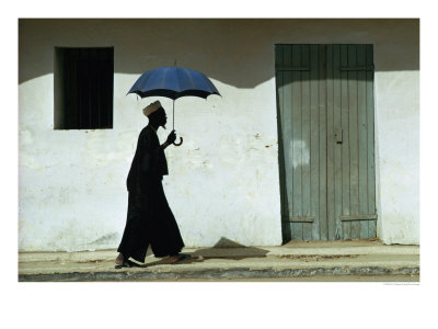 Man Walking With Umbrella, St. Louis, Senegal by Eric Wheater Pricing Limited Edition Print image