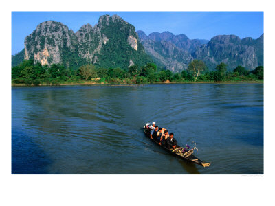 Longboat Crossing Nam Song From Limestone Formations With Honeycomb Caves, Vang Vieng, Laos by Kraig Lieb Pricing Limited Edition Print image