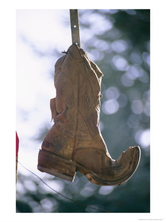 An Old Boot Decorates The Gate Of An Alleyway In Chimayo by Stephen St. John Pricing Limited Edition Print image