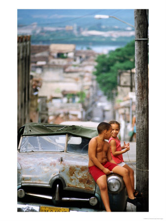 Young Children Sitting On Old Car, Santiago De Cuba, Cuba by Tom Cockrem Pricing Limited Edition Print image