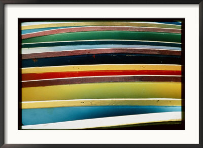 A Close-Up Of A Stack Of Boats Showing Bright Colored Stripes by Todd Gipstein Pricing Limited Edition Print image