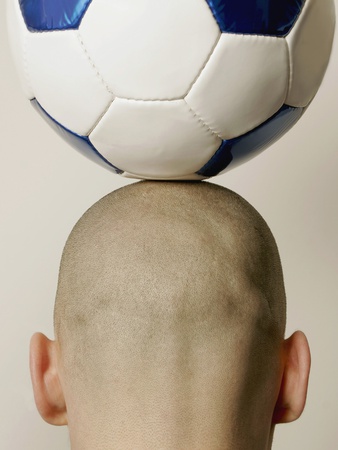 Man With Soccer Ball On Head, Rear View, Close-Up by Loop Delay Pricing Limited Edition Print image