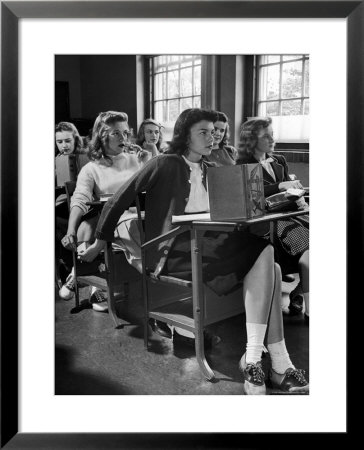 High School Student Passing Note To Classmate Sitting Behind Her by Nina Leen Pricing Limited Edition Print image