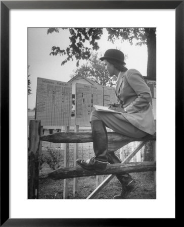 Betty Jane Baldwin Sitting On Fence And Looking At Official Board At Warrenton Horse Show by Martha Holmes Pricing Limited Edition Print image