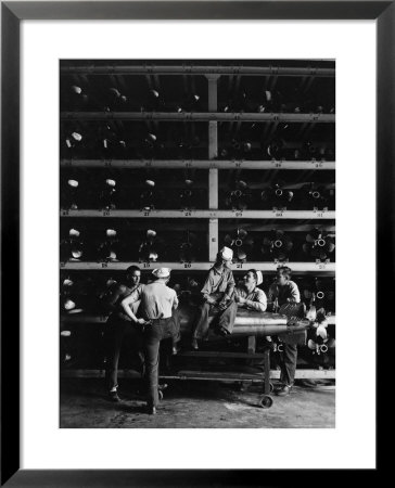 Torpedo Men Relaxing Beneath Rows Of Deadly Torpedoes In Torpedo Shop During Wwii by Horace Bristol Pricing Limited Edition Print image