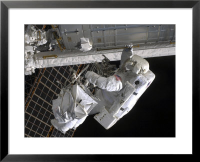Astronaut Participates In Extravehicular Activity On The International Space Station by Stocktrek Images Pricing Limited Edition Print image