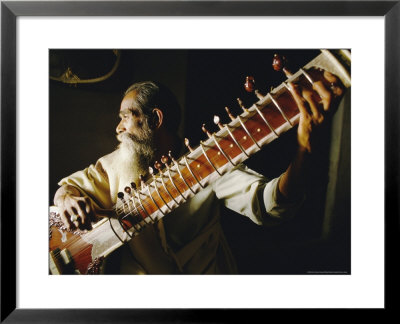 Portrait Of An Elderly Man Playing The Sitar, India by John Henry Claude Wilson Pricing Limited Edition Print image