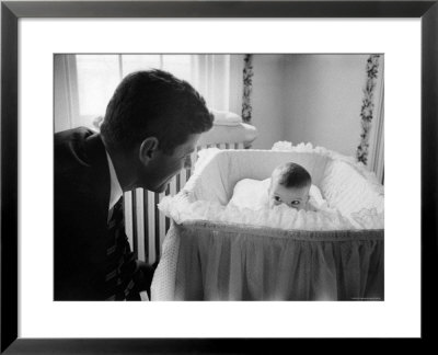 Sen. Jack Kennedy Admiring Baby Caroline As She Lies In Her Crib In Nursery At Georgetown Home by Ed Clark Pricing Limited Edition Print image