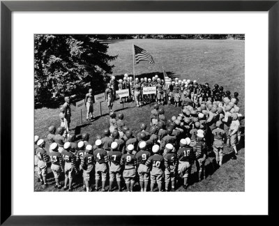 Boys In Circle For Ceremony Before Playing Young American Football League Games by Alfred Eisenstaedt Pricing Limited Edition Print image