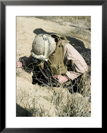 Us Marine Jumps Down A Hole Next To A Farm Field North Of Hit, Iraq, In Search Of A Weapons Cache by Stocktrek Images Pricing Limited Edition Print image