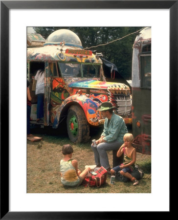 Man Seated With Two Young Boys In Front Of A Wildly Painted School Bus, Woodstock Music Art Fest by John Dominis Pricing Limited Edition Print image
