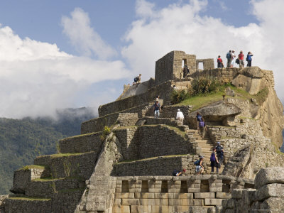 Tourists Climb The Intiwatana Pyramid, Machu Picchu, Peru by Dennis Kirkland Pricing Limited Edition Print image