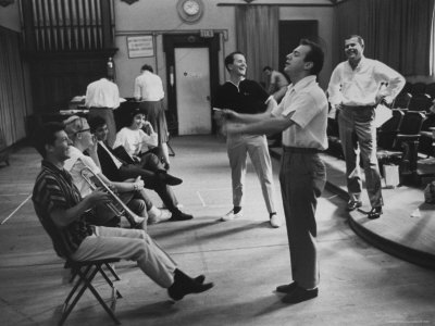 Bobby Darin Clowning As He Pretends To Conduct Frankie Avalon Playing A Trumpet by Peter Stackpole Pricing Limited Edition Print image