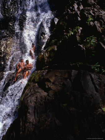 People Sliding Down Huai To Waterfall In Khao Phanom Bencha National Park, Krabi, Thailand by Bill Wassman Pricing Limited Edition Print image