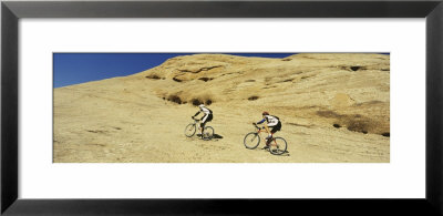 Two Men Mountain Bilking On Rocks, Slickrock Trail, Moab, Utah, Usa by Panoramic Images Pricing Limited Edition Print image