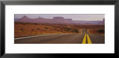 Highway Passing Through An Arid Landscape, Monument Valley Tribal Park, Arizona, Usa by Panoramic Images Pricing Limited Edition Print image