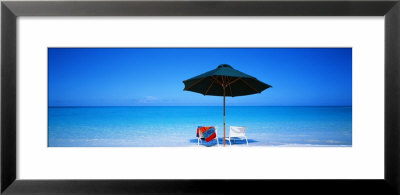 Chairs Under An Umbrella On The Beach, Turks And Caicos Islands, North Atlantic Ocean by Panoramic Images Pricing Limited Edition Print image