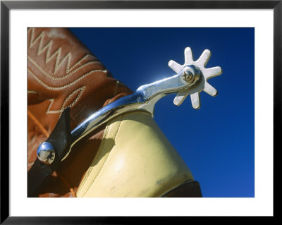A Close-Up Of A Shiny Silver Spur On The Back Of A Cowboy Boot by Todd Gipstein Pricing Limited Edition Print image