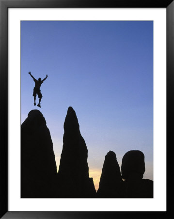 Silhouette Of Man Jumping On Top Of Rock by Greg Epperson Pricing Limited Edition Print image