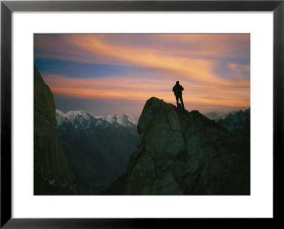 A Silhouetted Climber Watches The Sun Set Over The Karakoram Mountains by Bobby Model Pricing Limited Edition Print image
