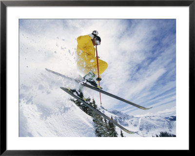 A Skier In A Yellow Suit Goes Airborne by Paul Chesley Pricing Limited Edition Print image