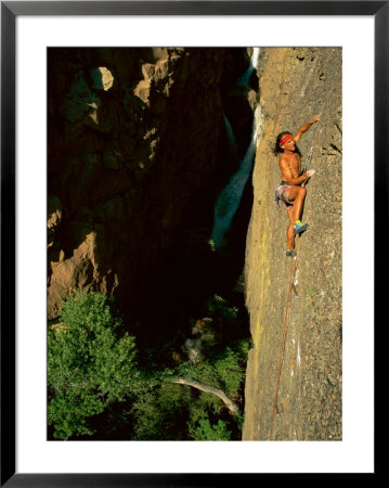 A Rock Climber Scales The Vertical Face Of A Mountain by Barry Tessman Pricing Limited Edition Print image