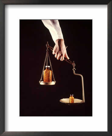 Large And Small Bottles Of Generic Pills Being Weighed On Balance Scale by Bill Eppridge Pricing Limited Edition Print image