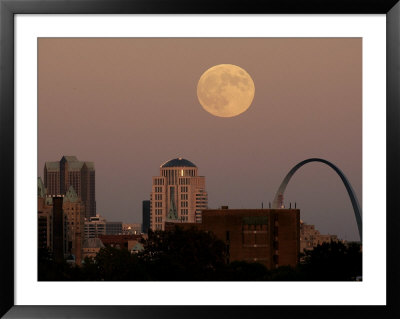 A Full Moon Rises Behind Downtown Saint Louis Buildings And The Gateway Arch, October 2006 by Charlie Riedel Pricing Limited Edition Print image