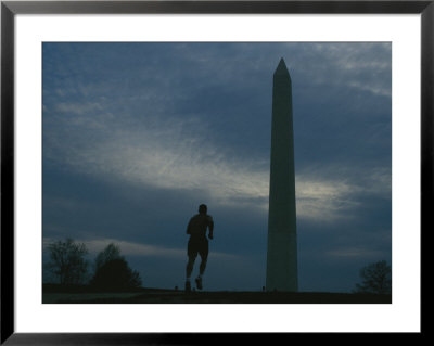 The Washington Monument Looms Above A Jogger by Joel Sartore Pricing Limited Edition Print image