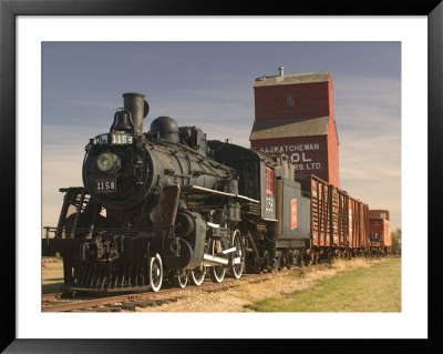 Steam Train And Grain Elevator In Western Development Museum, Saskatchewan, Canada by Walter Bibikow Pricing Limited Edition Print image