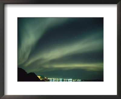 The Northern Lights Create Fantastic Patterns Over A City by Paul Nicklen Pricing Limited Edition Print image