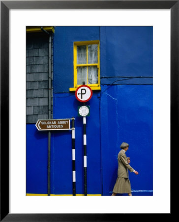 Woman Walking Past Building, Wexford, Ireland by Martin Moos Pricing Limited Edition Print image