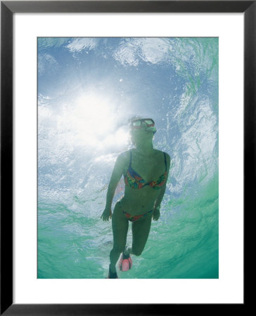 A Woman Swims Toward The Camera With The Sun Reflecting In The Water Behind Her by Barry Tessman Pricing Limited Edition Print image