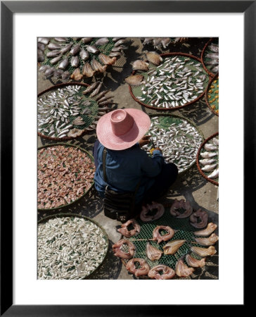 A Thai Woman Sells Dried Fish In Bangkok, Thailand, January 26, 2007 by Apichart Weerawong Pricing Limited Edition Print image