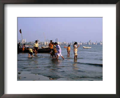 Locals Cooling Off In Polluted Waters At Chowpatty Beach, Mumbai, India by Peter Ptschelinzew Pricing Limited Edition Print image