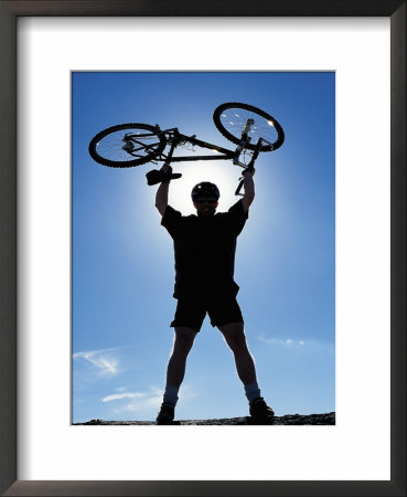 Silhouette Of Cyclist Holding Bike Over His Head by Charlie Borland Pricing Limited Edition Print image