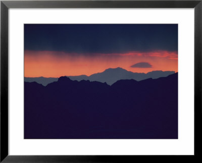 A Red Sun Sets Behind A Mountain Range Near Las Vegas by Maria Stenzel Pricing Limited Edition Print image