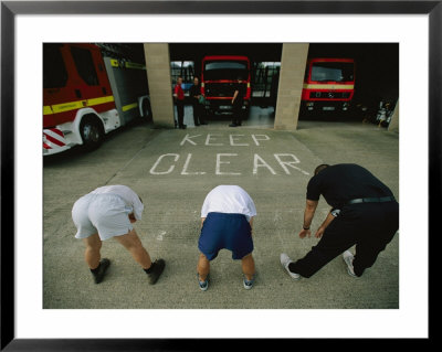 Fire Fighters Exercise And Stretch In Front Of Their Station by Joel Sartore Pricing Limited Edition Print image
