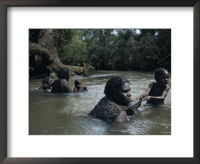 Aborigine Mothers And Children Cool Off During A Swim In A River by Randy Olson Pricing Limited Edition Print image