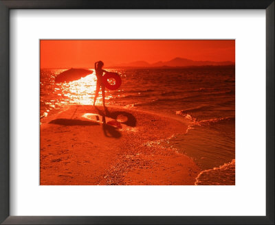 Woman With Inner Tube On Beach At Sunset, Brazil by Silvestre Machado Pricing Limited Edition Print image