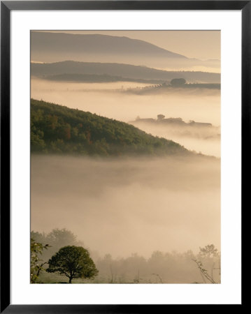 A Scenic View Of Fog Hovering Over The Umbrian Landscape by Tino Soriano Pricing Limited Edition Print image