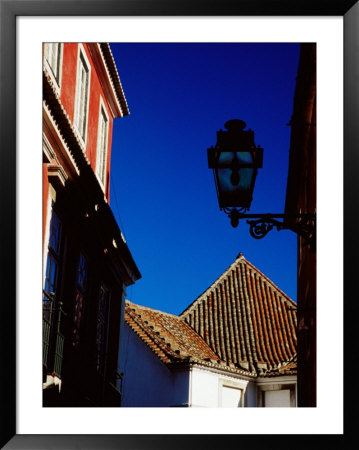 Building Facade, Roof And Street Lamp In Alfama District, Lisbon, Portugal by Izzet Keribar Pricing Limited Edition Print image