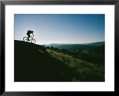A Bicyclist Rides Along The Ridge Of A Mountain by Skip Brown Pricing Limited Edition Print image