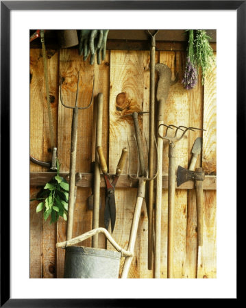 Garden Tools Hanging In Shed Fork, Shears, Rake, Lopper, Axe, Saw & Gardening Gloves by Martine Mouchy Pricing Limited Edition Print image