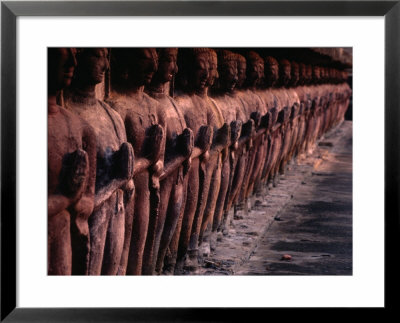 Ancient Buddha Statues Lining Walls Of Wat Mahathat In Sukhothai Historical Park, Thailand by Cheryl Conlon Pricing Limited Edition Print image