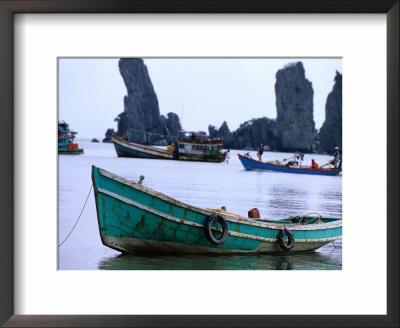 Fishing Boats In Front Of The Father And Son Rock Formations At Duong Beach Near Ha Tien, Vietnam by John Banagan Pricing Limited Edition Print image