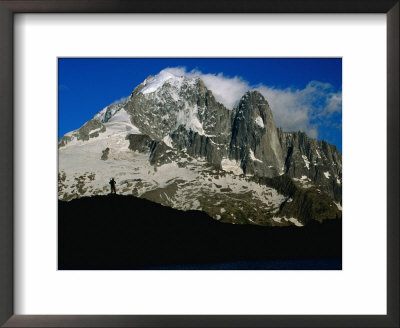 Walker Silhouetted Against Aiguille Verte On Tour Du Mont Blanc, Chamonix Valley, France by Gareth Mccormack Pricing Limited Edition Print image