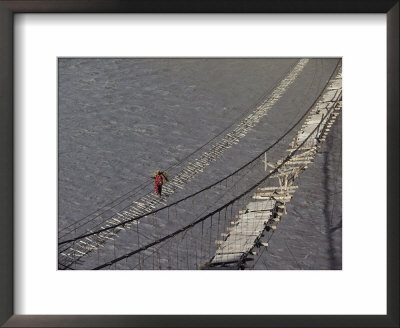 A Hunzukut Woman Crosses A Footbridge Over The Hunza River, Constructed Of Tied Juniper Branches by Jonathan Blair Pricing Limited Edition Print image