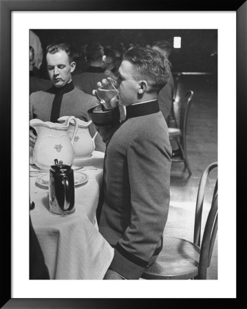 West Point Cadet Drinking A Glass Of Water As He Sits At Attention In Mess Hall At The Academy by Alfred Eisenstaedt Pricing Limited Edition Print image