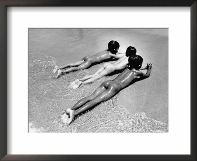 Three Native Boys Sunbathing Nude At The Edge Of The Surf At Ocean Beach by Howard Sochurek Pricing Limited Edition Print image